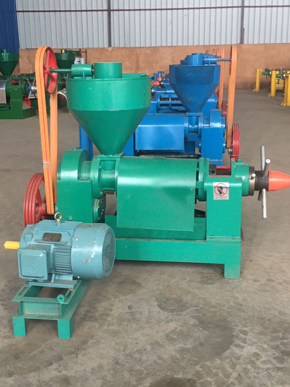 Heavy-duty green motorised screw press unit